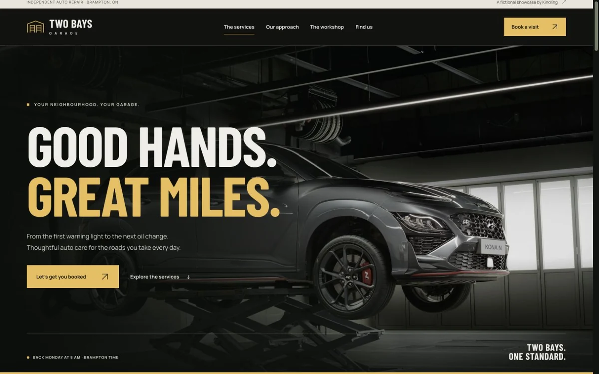 Two Bays Garage website: cinematic garage photography, bold cream and amber lettering, and a visit booking preview